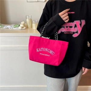 Rose red nylon tote bag with woven handles and side pockets for casual daily use