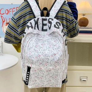 White canvas backpack with colorful ink splashes and AKESS print for casual outdoor travel