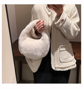 Close-up of white plush handbag styled with a classic tweed jacket for daily fashion