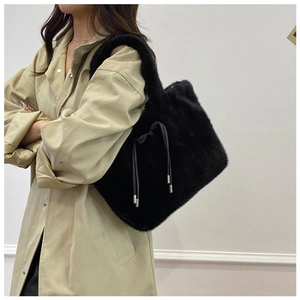 Close-up of black faux fur tote bag showing the soft texture and drawstring closure