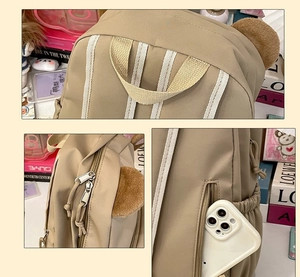 Close-up of khaki school backpack features plush bear ears and waterproof nylon fabric detail