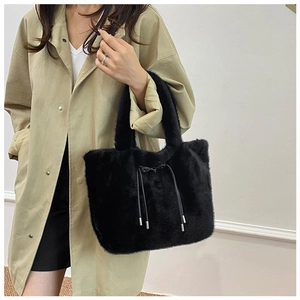 Detail of black faux fur tote bag showing plush texture and adjustable drawstring accents