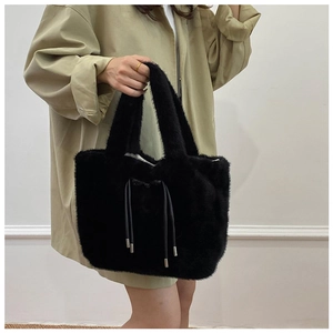 Detail of black faux fur tote bag showing the plush texture and drawstring feature