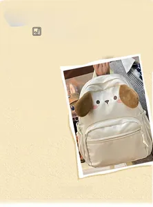 Detailed close-up of the white cartoon dog backpack featuring plush ears and clear pocket