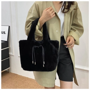 Detail of black faux fur tote bag showing the plush texture and leather drawstring tassels