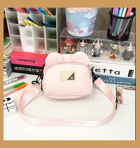 Detailed macro view of the cute pink canvas bag with bear ears and leather logo patch