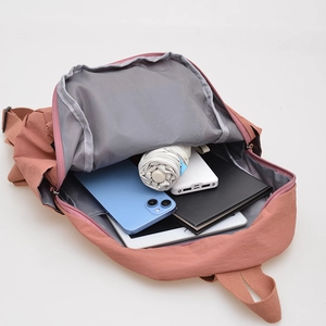 Waterproof nylon backpack in dusty rose pink showing spacious interior storage