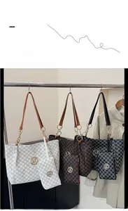 Detail view of the monogram printed tote bag set with metal M logo and matching pouch