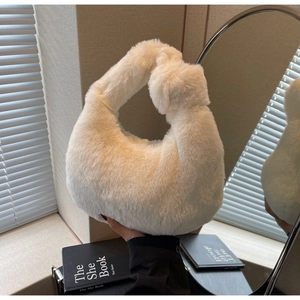 Close-up of fluffy white faux fur handbag featuring a stylish knotted handle detail