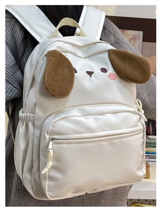 Close-up of white cartoon backpack featuring cute 3D plush ears and detailed embroidery