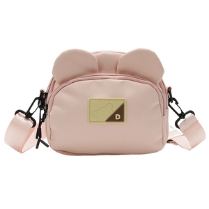 Close-up of pink cartoon bear ears on fabric crossbody bag with adjustable strap