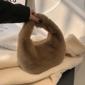 Detail of soft camel plush hobo bag showing fluffy faux fur texture and seamless handle