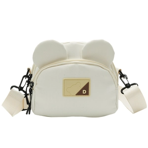 Detailed macro view of the cute bear ears and textured canvas fabric on the small crossbody bag