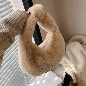 Close-up of fluffy faux fur handbag in camel beige showing soft plush texture and crescent design