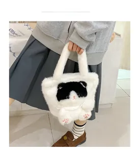 Detail view of a white plush cat bucket bag with cute embroidered facial features