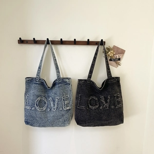 Retro washed denim tote bag with oversized L.O.V.E. fringe letters in light blue and dark grey