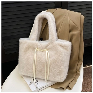 Detailed close-up of cream faux fur tote bag with buckle accents and soft texture