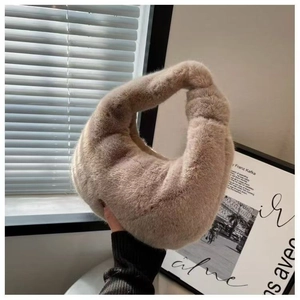 Detailed view of light camel plush handbag with soft faux fur texture and knotted handle