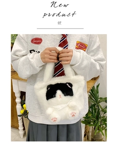 Detail of white plush cat handbag with cute embroidery and soft faux fur texture