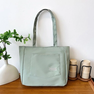 Minimalist light green nylon tote bag for women featuring a stylish fashion label tag