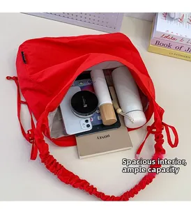 Macro shot of spacious bright red nylon bag interior showing tablet and daily essentials