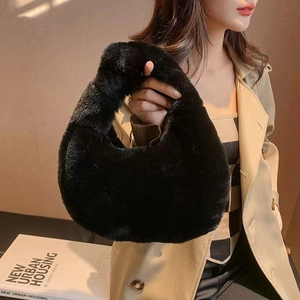 Chic black faux fur tote bag with a minimalist design for stylish autumn and winter outfits