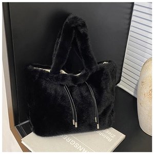 Detail of black faux rabbit fur tote bag featuring plush texture and decorative drawstrings