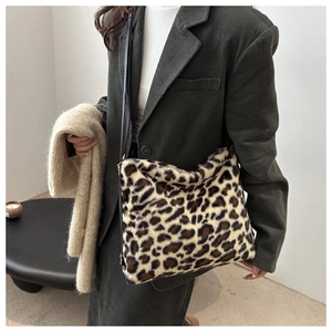 Detail of leopard print faux fur texture on a soft winter crossbody bag with black strap
