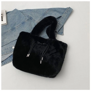 Detail of black faux fur tote bag featuring fine drawstring and silver metal tips