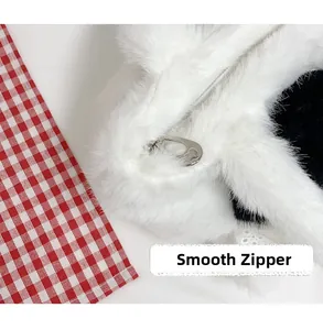 Detail of a smooth silver metal zipper on a soft plush faux fur cat bucket bag for women