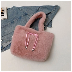 Detail of the soft pink plush tote bag with a decorative knotted drawstring and metal tips