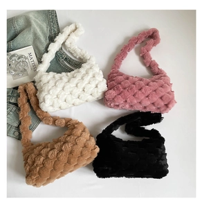 Detail view of woven plush tote bags in white, pink, camel and black for autumn winter