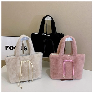 Detailed view of plush tote bags with bow tie drawstring in cream, black, and lotus pink