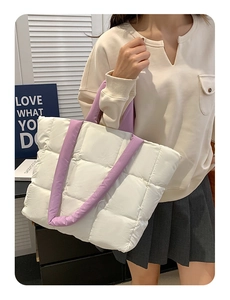 Quilted cloud tote bag detail showing large capacity and purple straps on female model