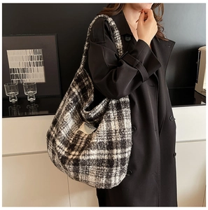 Detailed close-up of the black and white plaid wool tote bag with SEEYOU logo label
