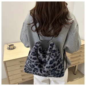 Detail of grey leopard print faux fur tote bag with slim black shoulder straps