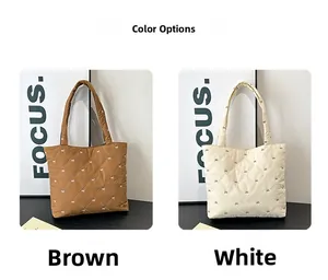 Quilted tote bag detail showing brown and white options with small bow patterns