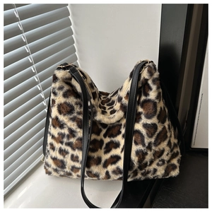 Detail of leopard print faux fur tote bag showing soft texture and black leather straps