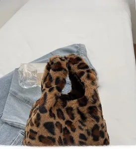 Close-up of leopard print faux fur handbag with soft texture and sturdy handle design
