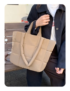 Close-up of the khaki padded puffer tote bag showing quilted texture and soft fabric