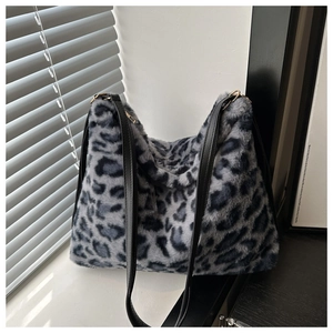 Macro shot of grey leopard print faux fur texture and black leather shoulder strap