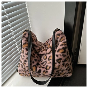 Detailed macro view of pink leopard print faux fur texture and black leather shoulder straps