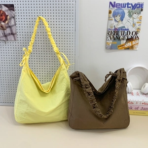 Minimalist nylon cloud-style tote bag with gathered drawstring shoulder straps in two colors