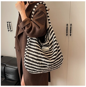 Detail of black and white striped plush tote bag showing fuzzy texture and SEEYOU label