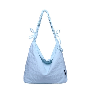 Light blue nylon cloud bag with ruched drawstring straps and bow accents on white background