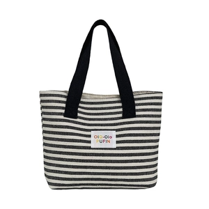 Large black and white striped canvas tote bag with sturdy handles for commuting
