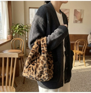 Close-up of fluffy leopard print plush handbag with soft faux fur texture for winter