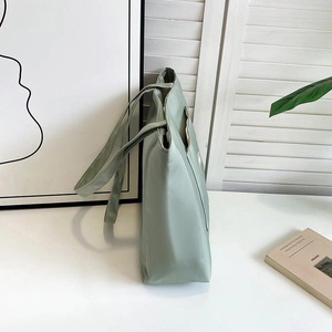 Detail view of large nylon tote bag in light green with side pocket for commuting