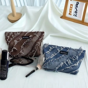 Vintage denim fringe cosmetic bag with Moonshine label and tassel patchwork details