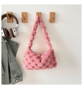 Detail view of pink plush crossbody bag with textured bubble weave and soft faux fur material